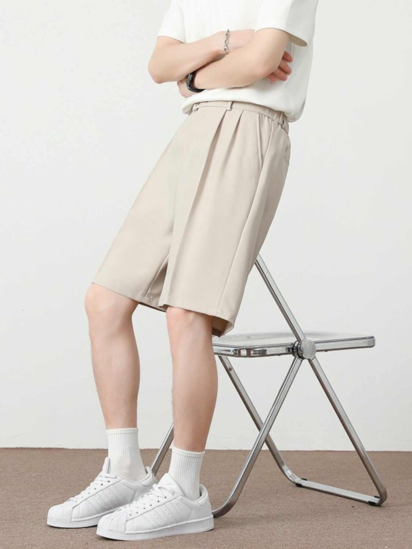 Cream pleated detail loose-fit chino shorts with a relaxed cut.