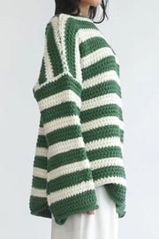 Green and white striped boat neck knit sweater with chunky texture.