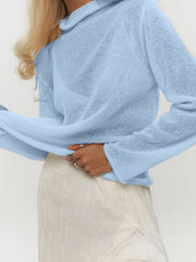Blue sheer mock neck knit sweater with draped fit and long sleeves.