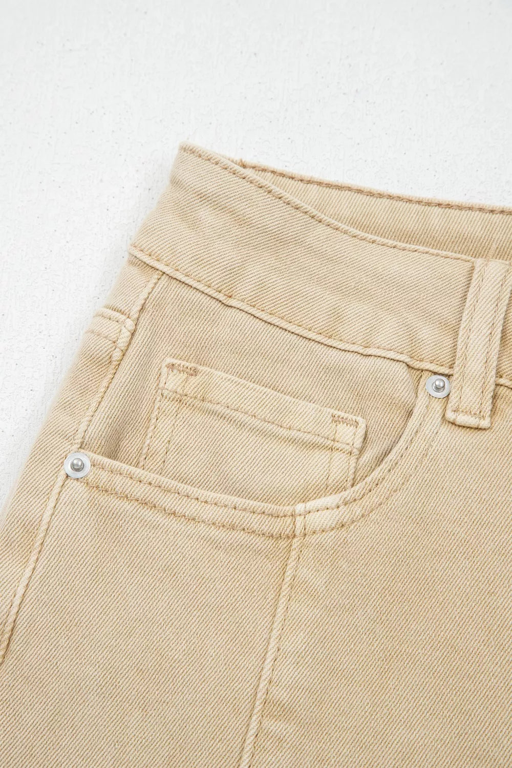 High-waisted cropped wide-leg jeans in tan denim with front pockets and silver rivets.