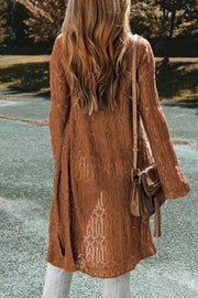 Brown openwork maxi cardigan with intricate lace details and bell sleeves.