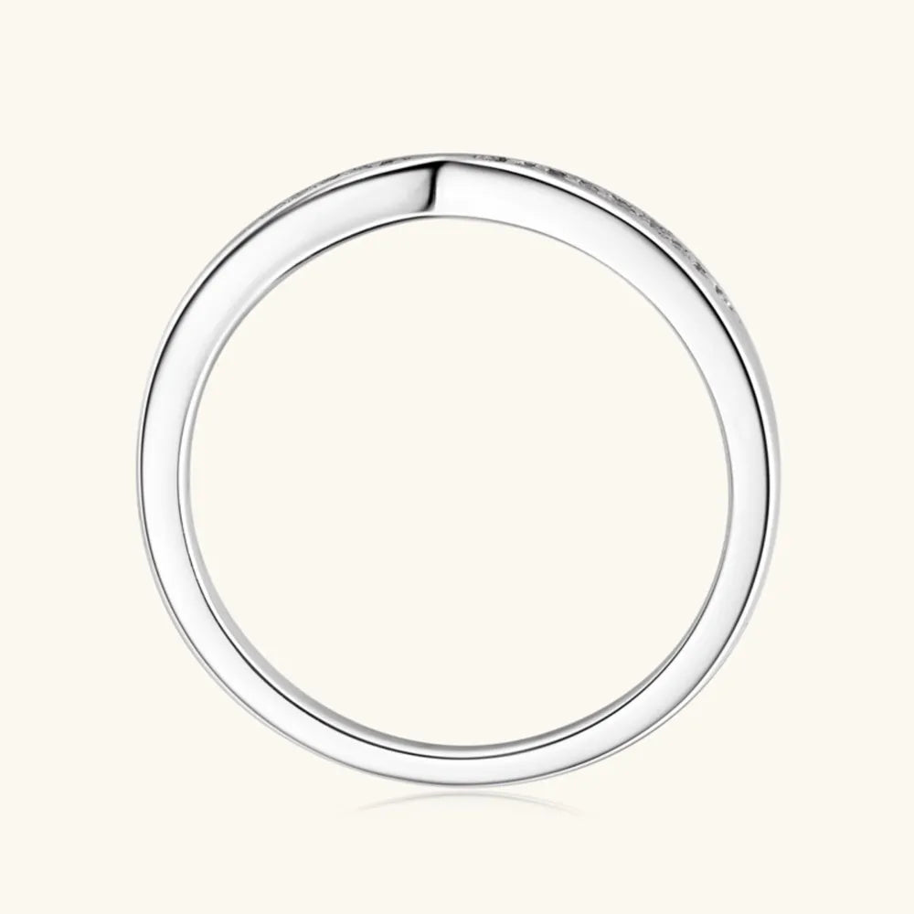 Silver moissanite chevron contour band ring with small stones.