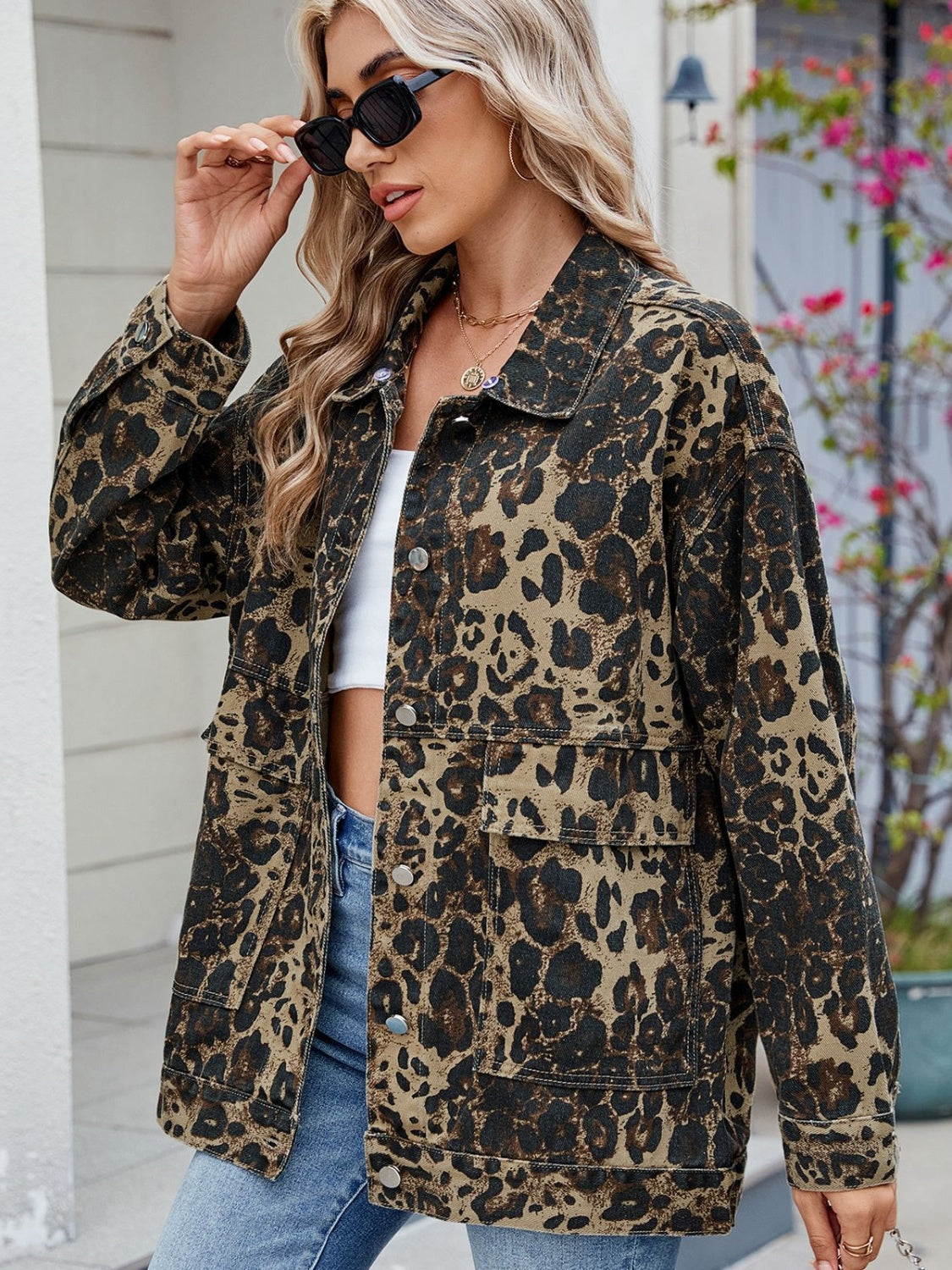 Leopard print denim utility jacket with chest pockets and button front.