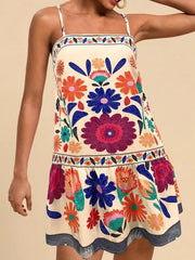 Vibrant floral print mini dress with spaghetti straps and a tiered hem.
