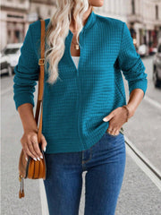 French Blue quilted bomber jacket with zip closure and stand-up collar.