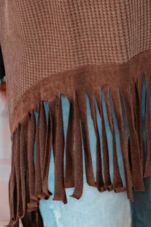 Brown waffle knit top with suede fringe hem detail.