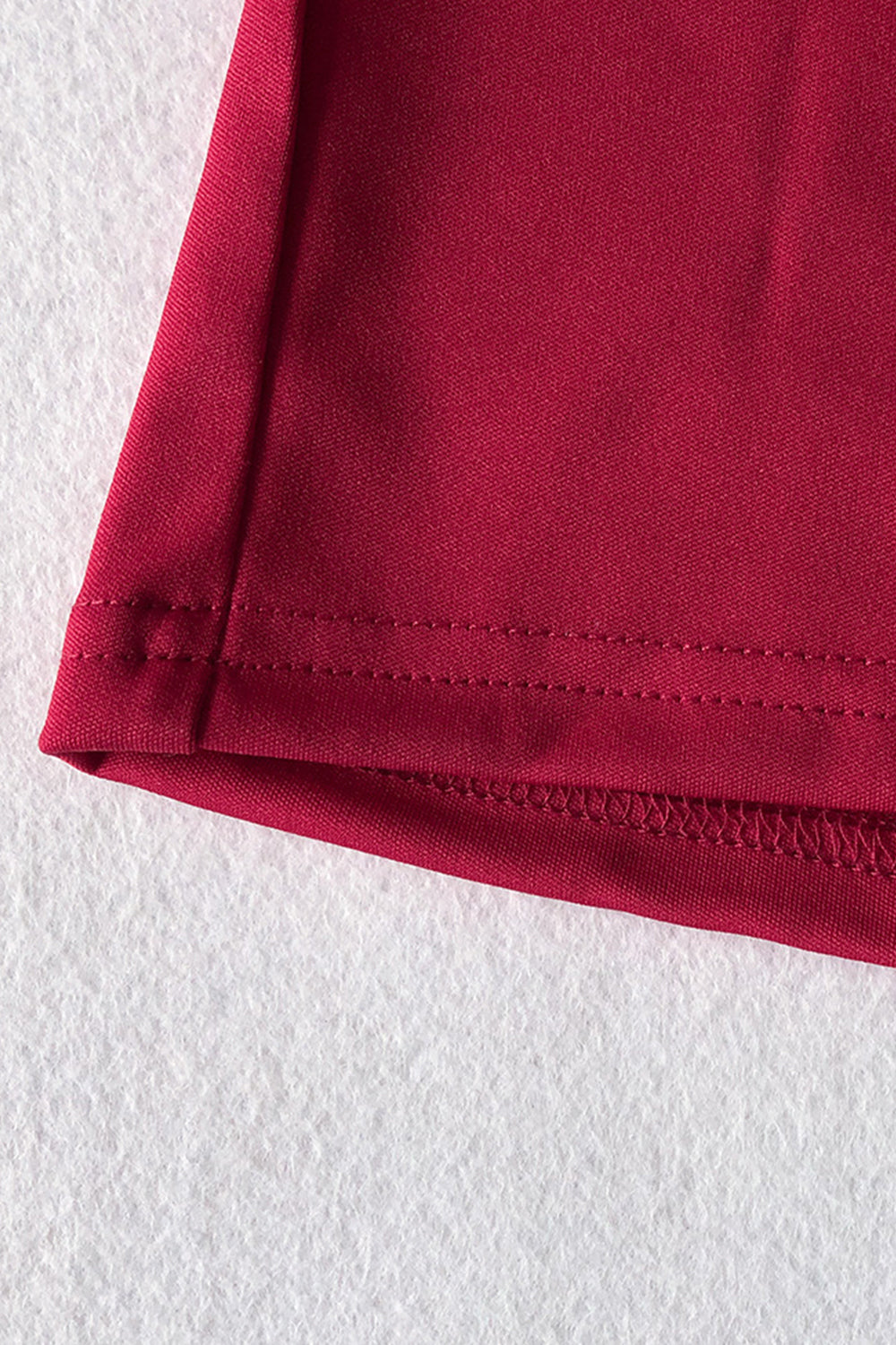 Deep Red belted palazzo jumpsuit hem detail with double stitching