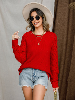 Diamond-cut raglan knit sweater in deep red with open knit diamond pattern on sleeves.