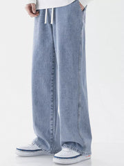 Light blue relaxed wide-leg jeans with drawstring waist and pockets.