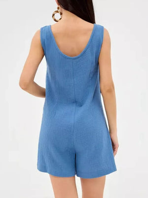 Blue crinkled cotton sleeveless button-down romper with a U-neckline.