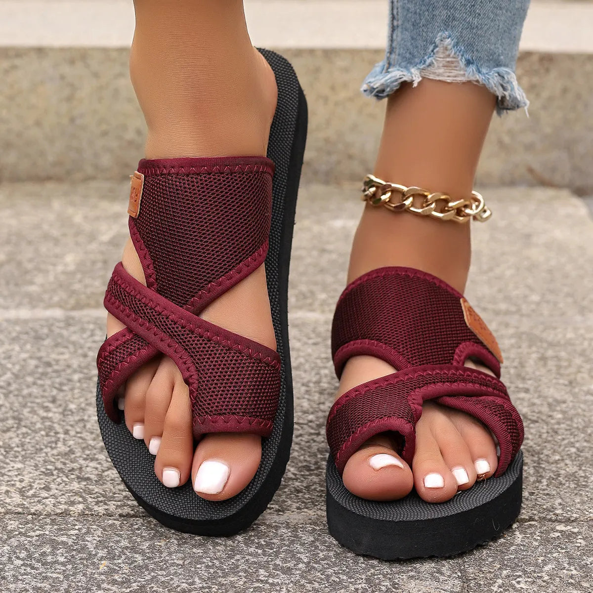 Cross-strap mesh platform slides in deep purple with a toe loop and adjustable strap.