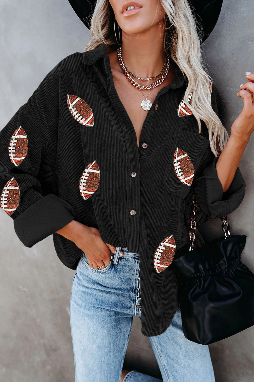 Black corduroy shirt jacket with all-over football embellishments and button front.