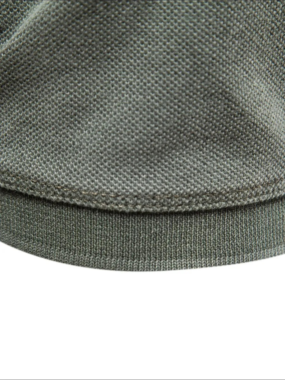 Sage textured polo shirt hem detail with ribbed band