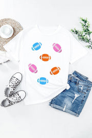 White t-shirt with rolled sleeves and scattered colorful football graphics.