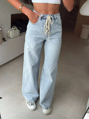 Light wash denim wide leg jeans with lace-up front detail.