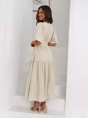 Beige puff sleeve midi dress with tiered skirt and cinched waist.