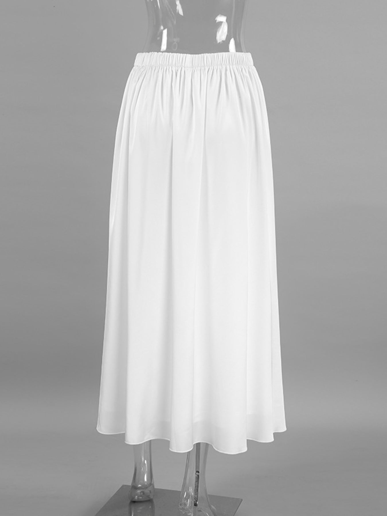 White high-waisted maxi skirt with elastic waistband and flowy silhouette.