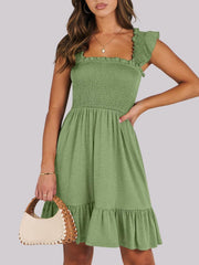 Sage smocked ruffle hem mini dress with square neckline and flutter sleeves.