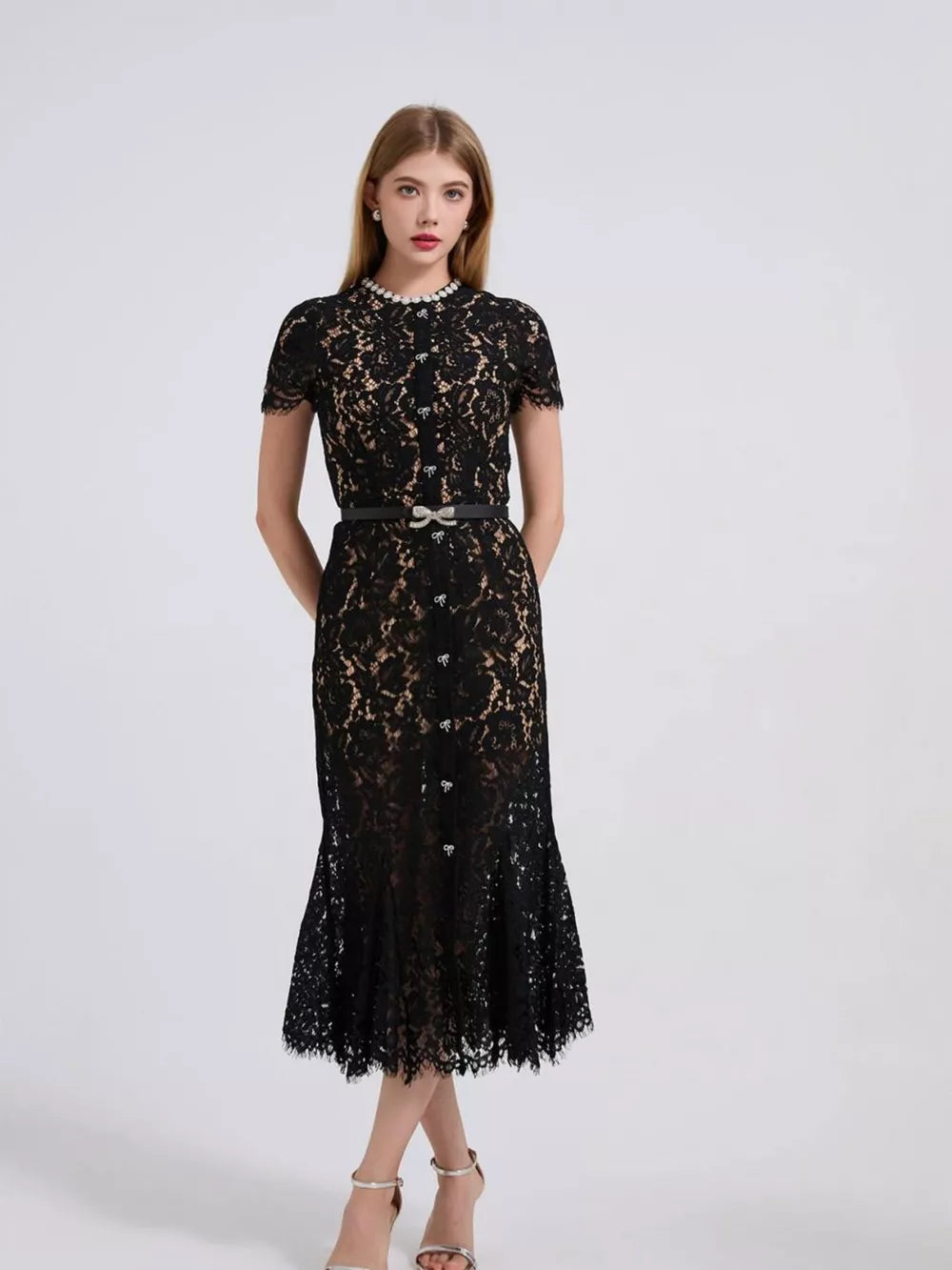 Black lace mermaid dress with short sleeves, pearl neckline, and jeweled bow belt.