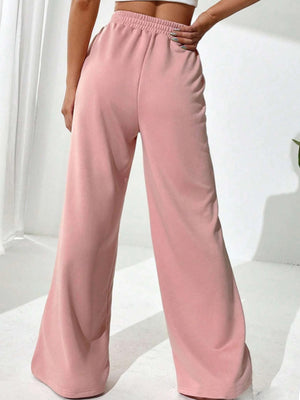 Blush pink palazzo sweatpants with V-waistline and center seams.
