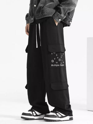 Black drawstring cargo sweatpants with multiple pockets and graphic detail.