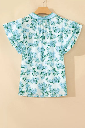 Floral print polyester blouse with flutter sleeves and ruffled neckline detail.