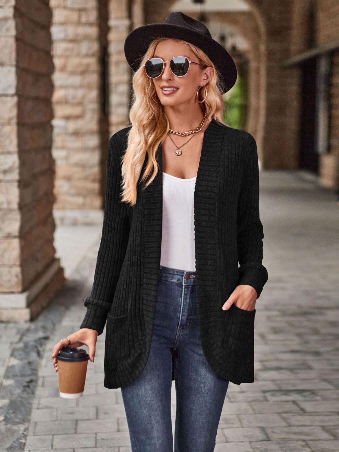 Black textured ribbed open-front cardigan with pockets and long sleeves.