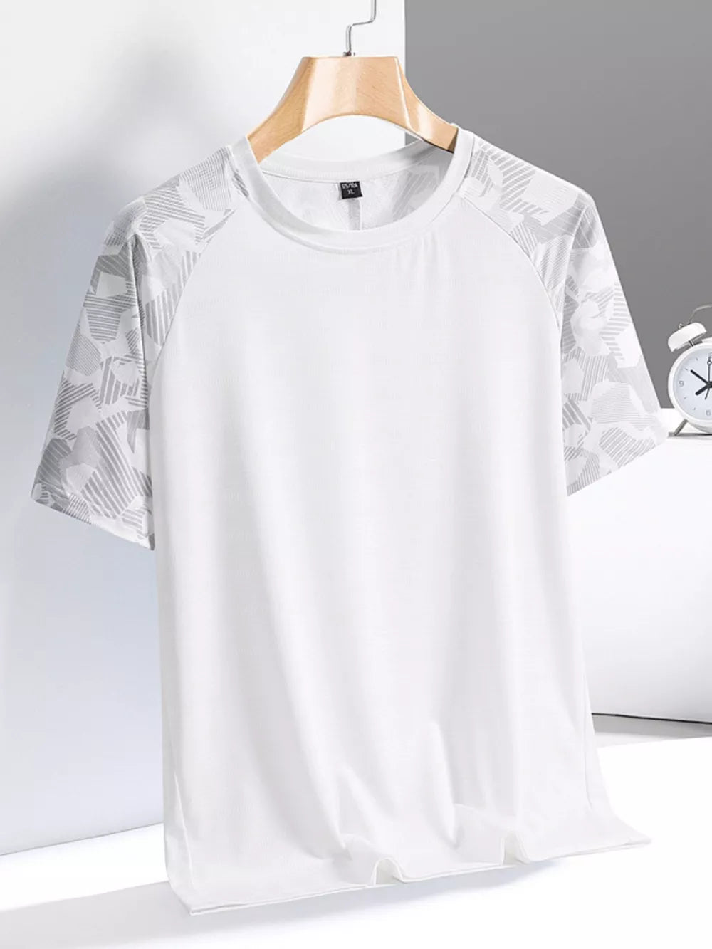 Men's white activewear tee with grey geometric patterned sleeves and crew neck.