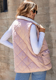 Quilted sherpa-lined utility vest in blush pink with two front pockets.