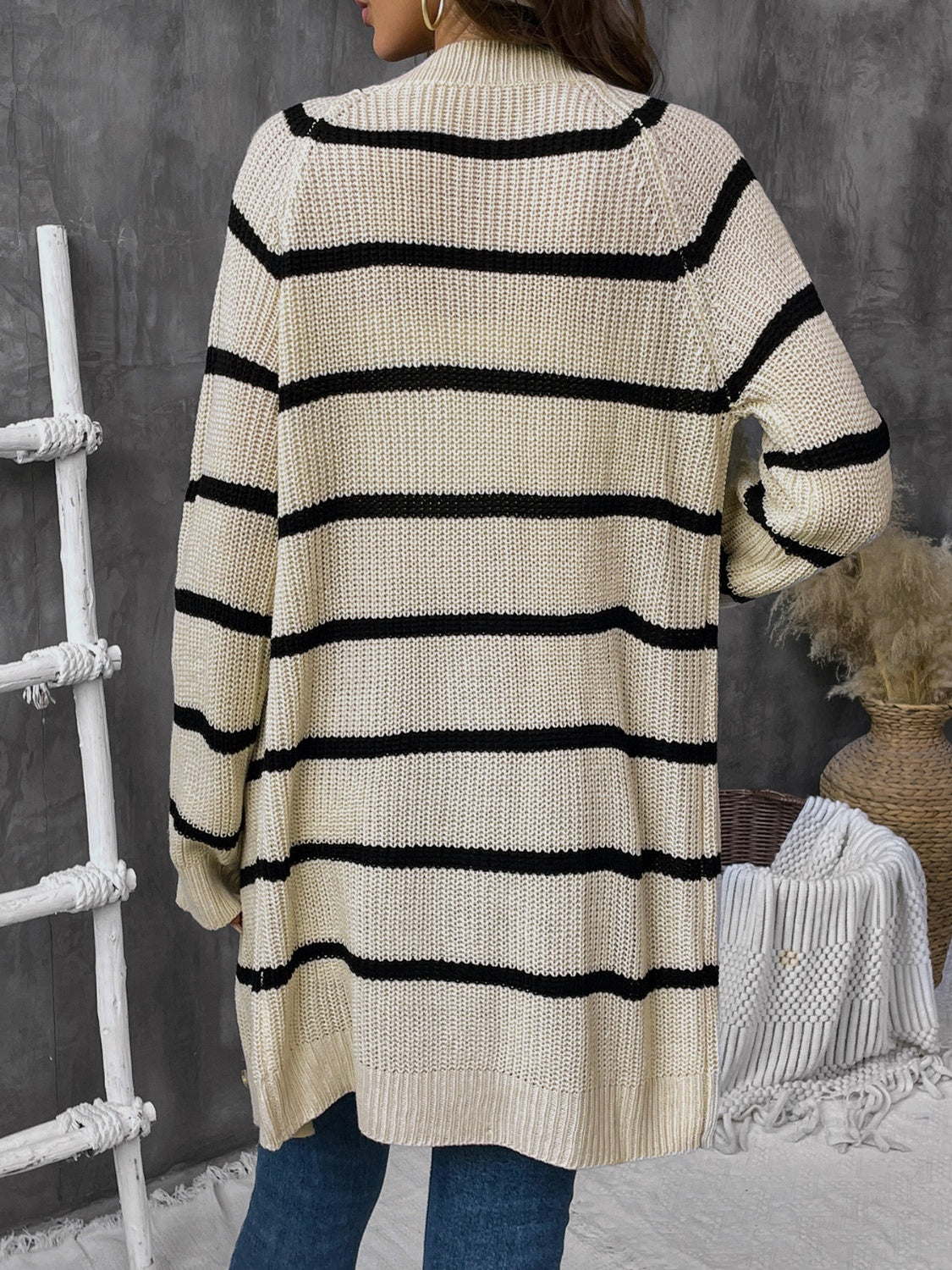 Beige acrylic knit cardigan with wide black stripes and button front.