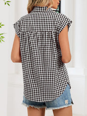 Black gingham cotton shirt with cap sleeves and button-down front, styled with denim shorts.