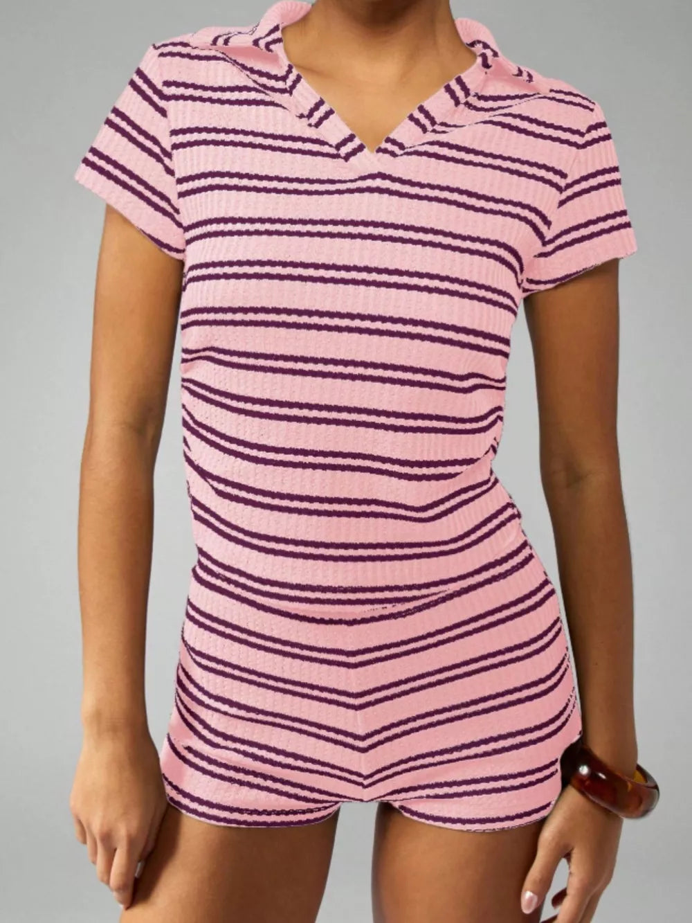 Pink striped knit two-piece set with collared neckline and short sleeves.