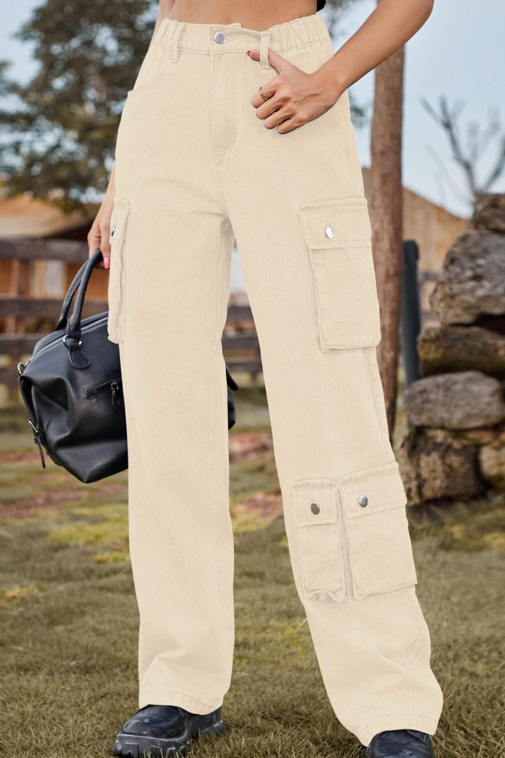 Tan relaxed wide leg cargo pants with multiple utility pockets.
