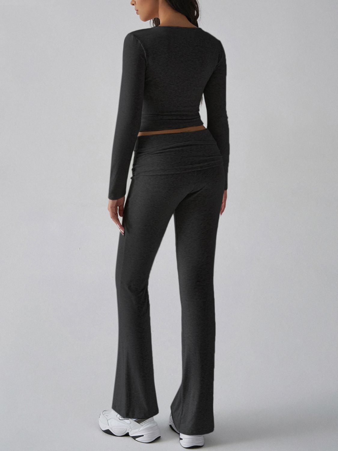 Black long sleeve loungewear set with flared pants and square neck top.