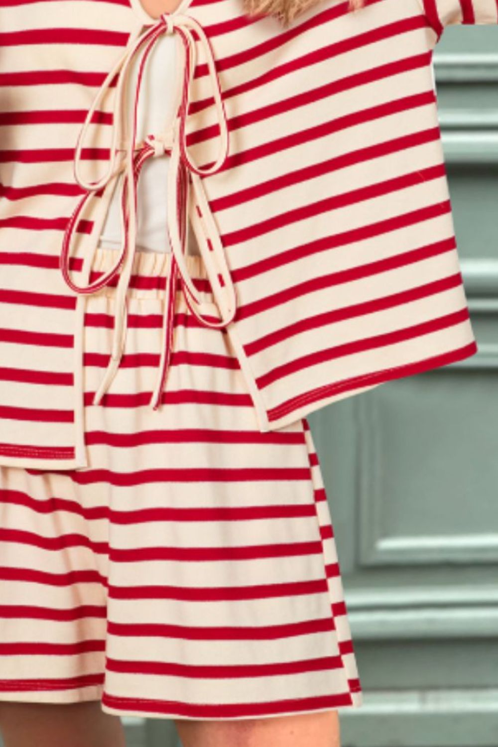 Tie-front lounge set with red and white stripes, featuring a bow detail on the top and matching shorts.