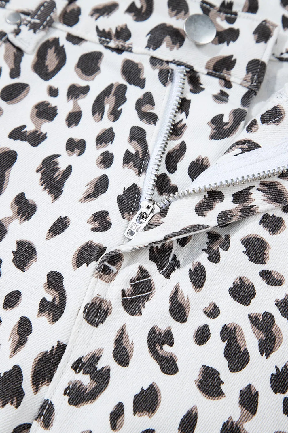 Leopard print denim shorts with frayed hem detail and zip fly.