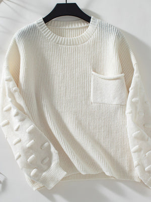 Ivory knit sweater with textured sleeve details and a chest pocket.