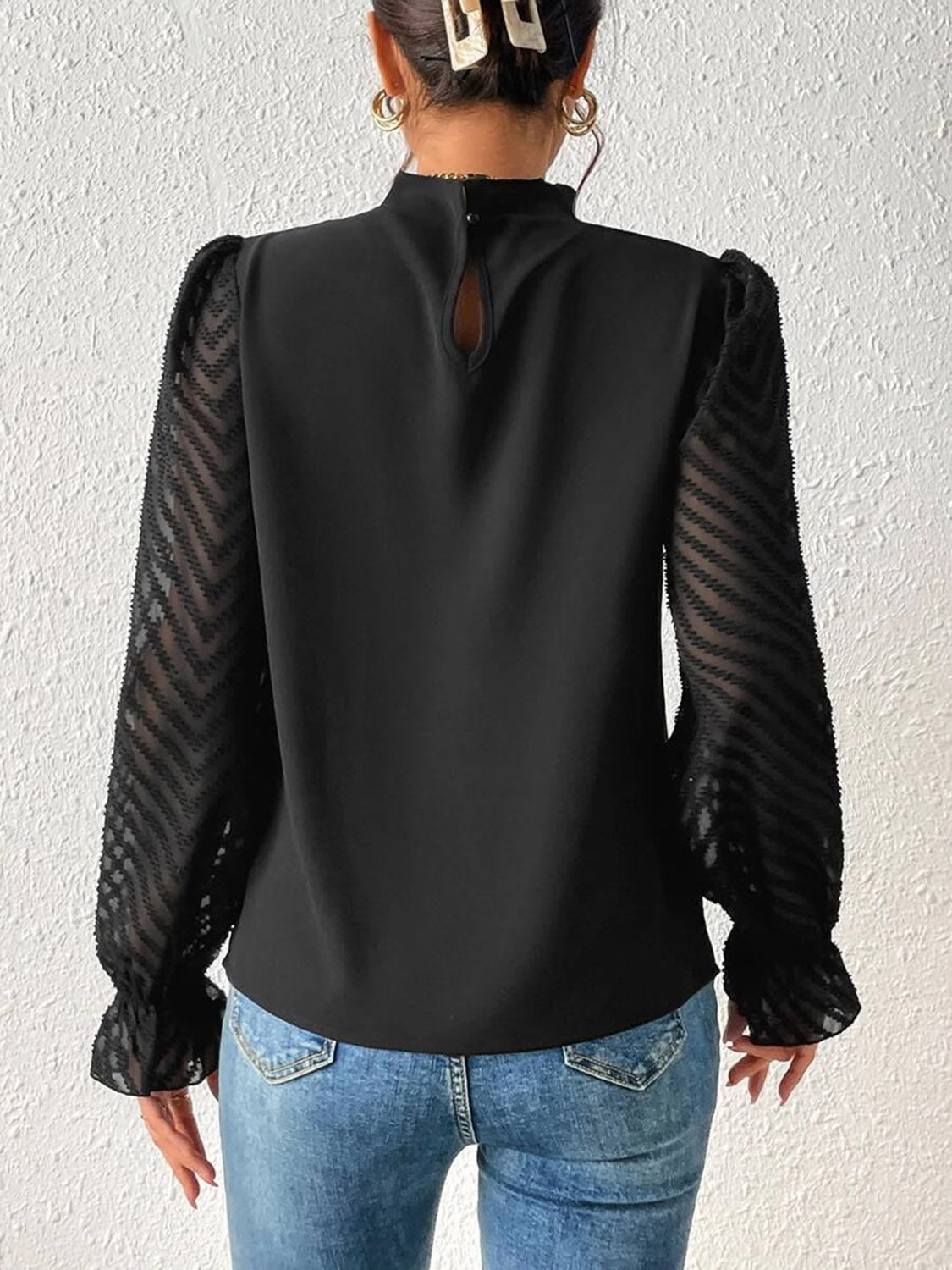 Black Chevron Sleeve Ruffle Neck Blouse with sheer chevron patterned sleeves and ruffled cuffs.