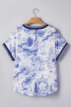 Blue and white toile print v-neck blouse with striped cuffs and neckline.