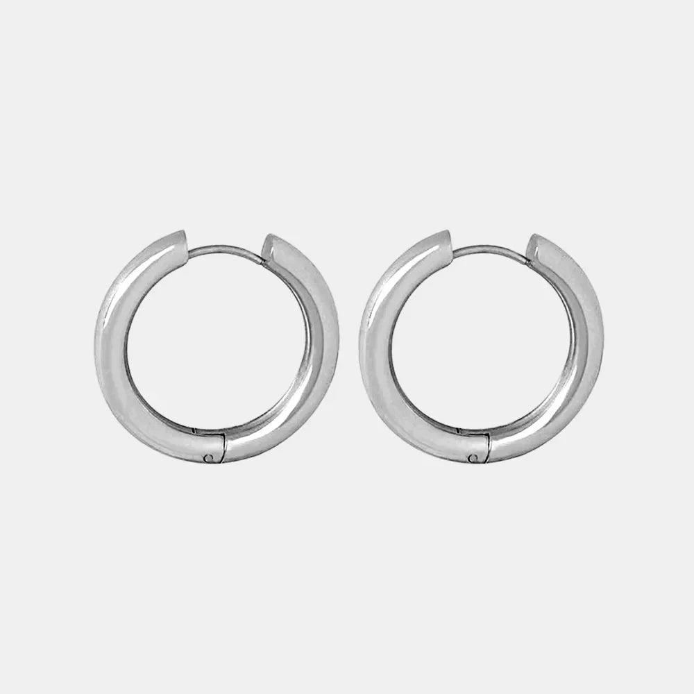 Sculpted silver hoop earrings with a polished finish.