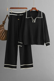 Black ribbed knit loungewear set with contrast trim, collared V-neck top and wide-leg pants.