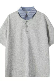 Light gray relaxed fit polo with buttoned placket and blue striped collar.