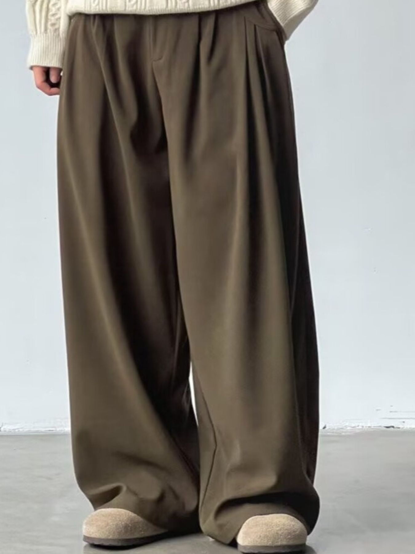 Men's dark brown wide leg casual sweatpants with pleats and a relaxed fit.