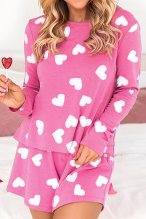 Hot pink heart print pajama set with long sleeve top and elastic waist shorts.