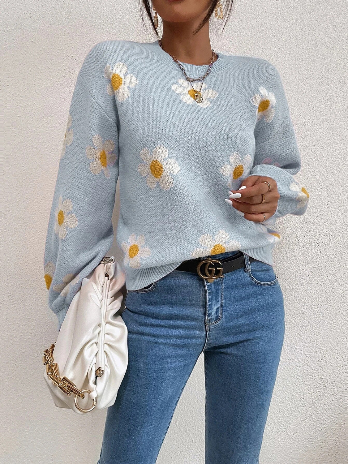 Misty Blue knit sweater with all-over white daisy print and puff sleeves.