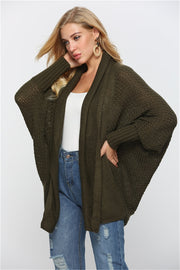 Textured cocoon knit cardigan in dark green with batwing sleeves and open front.