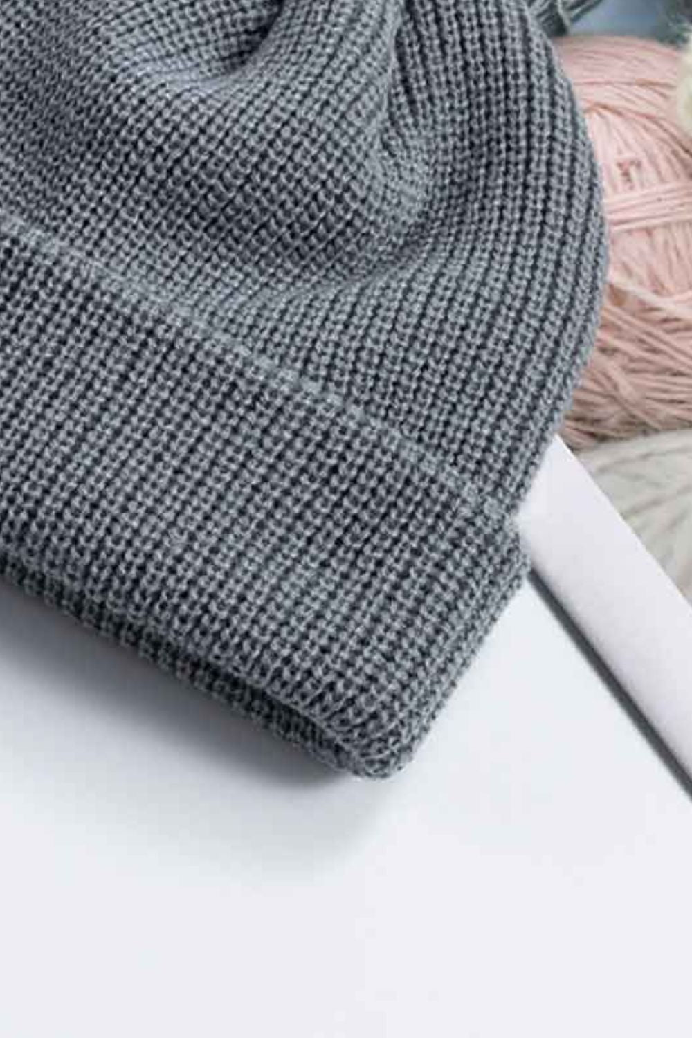 Gray ribbed knit beanie with a turn-up cuff.