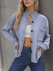 Light blue acrylic knit cardigan with stand collar, buttons, and pockets.