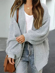 Gray chunky knit cocoon cardigan with balloon sleeves and open front, styled with jeans.