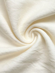 Beige lace-trimmed V-neck maxi dress detail showing textured fabric